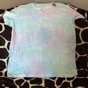 Pink women’s tie dyed V neck tee shirt. Letting is in white.